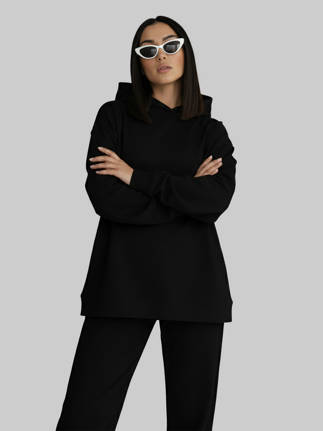 Women wearing black oversized hoodie with relaxed streetwear style