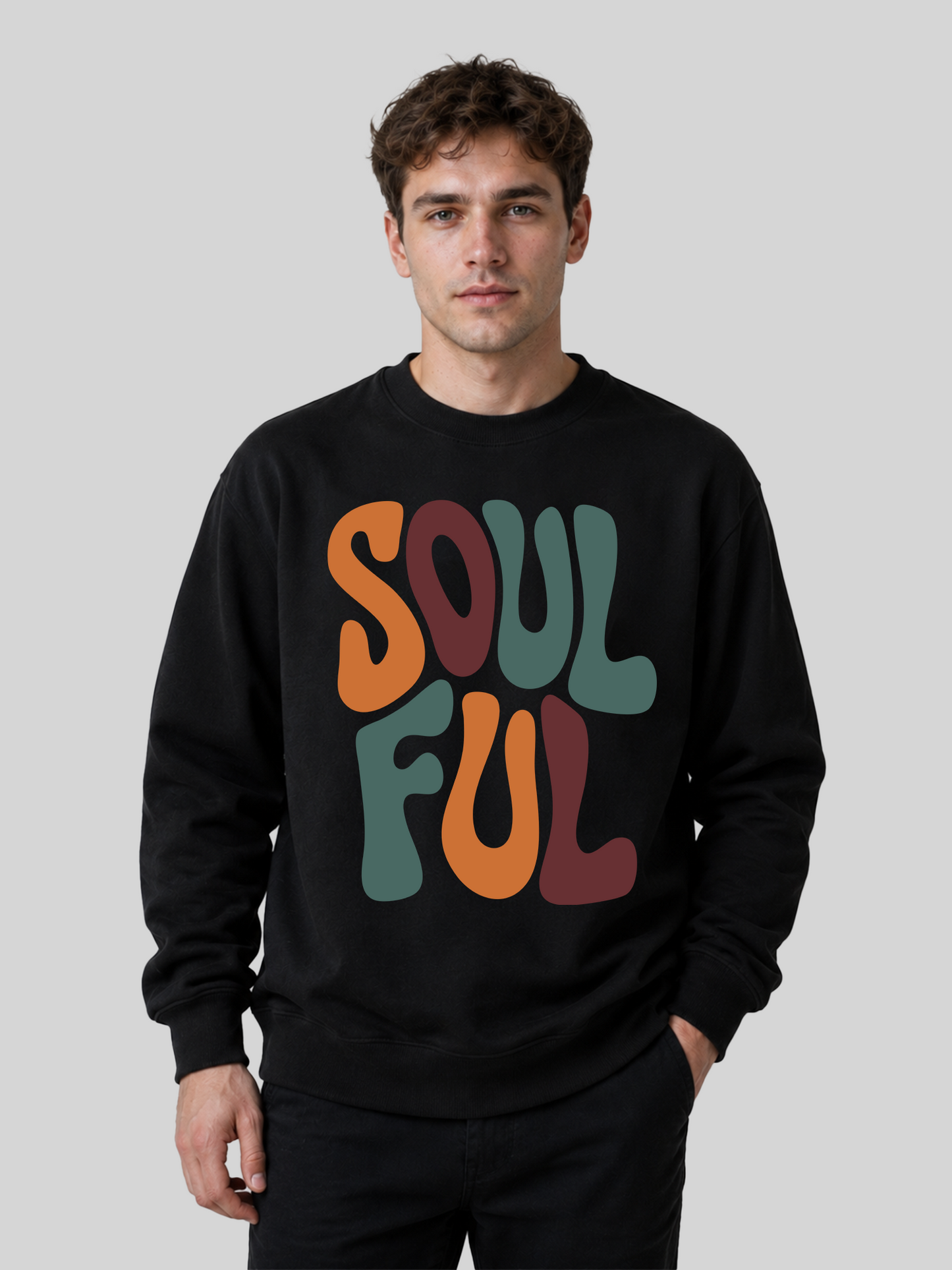 A front view of a male model wearing a black crewneck sweatshirt with a large, colorful retro typography print reading "SOULFUL" across the chest.