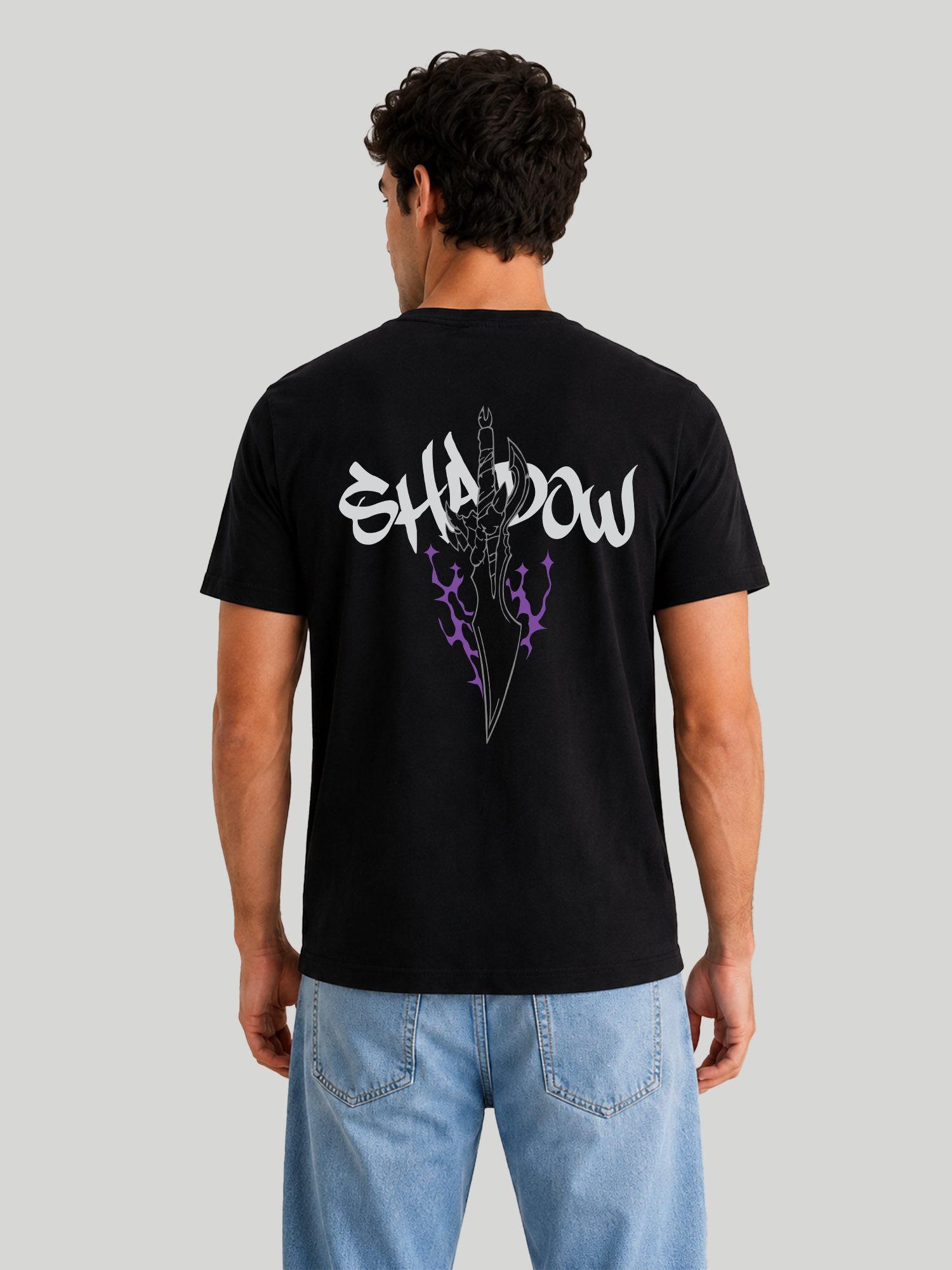 A straight rear view of a male model showcasing the regular fit of a black graphic streetwear t-shirt with custom anime-inspired back print.
