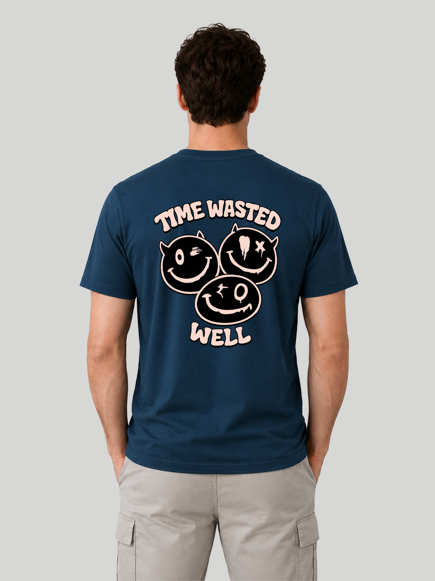 A straight rear view of a male model showcasing a custom printed navy blue graphic streetwear t-shirt with a pink text and cartoon design.