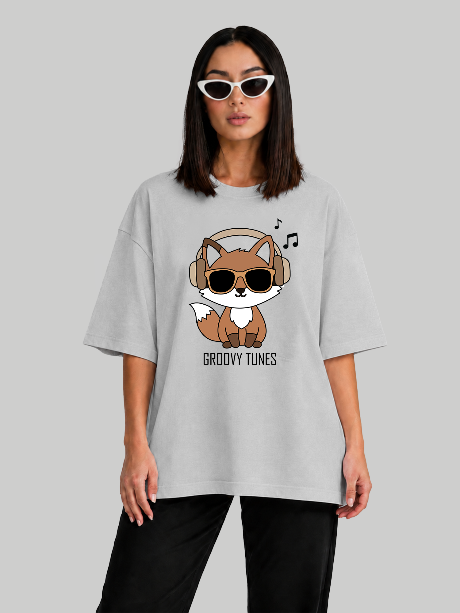 Women's oversized ash grey Groovy Tunes t-shirt featuring a fox wearing headphones and sunglasses, relaxed front view.