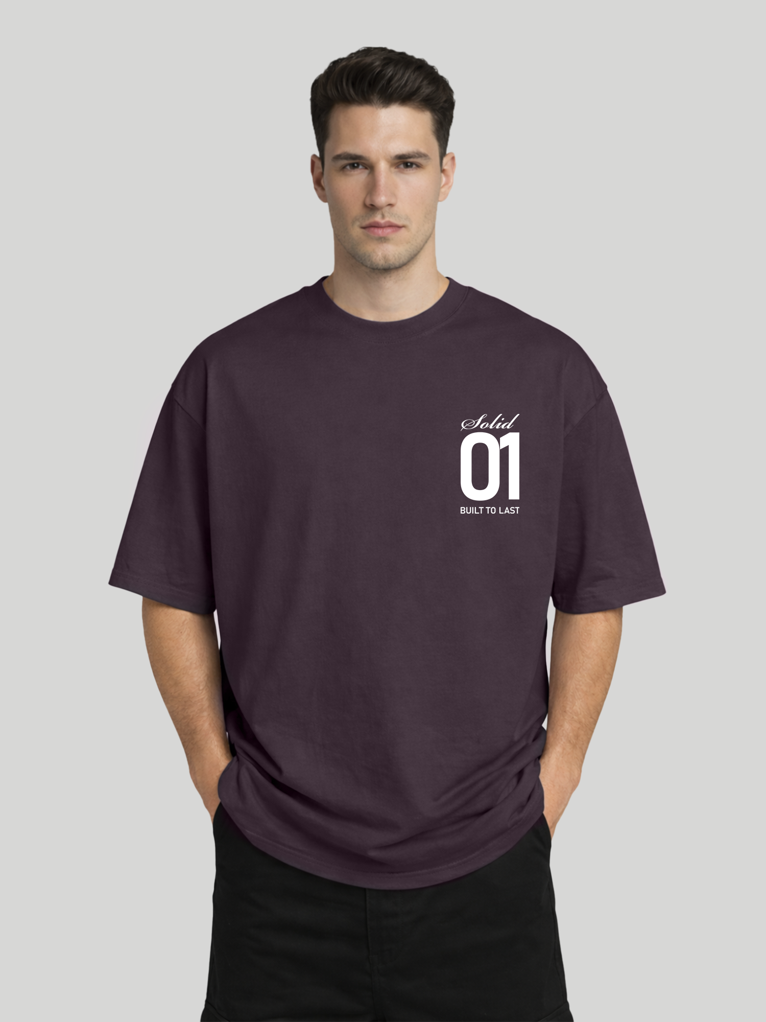 Man wearing plum oversized t-shirt with Solid 01 chest print in relaxed pose with hands in pockets