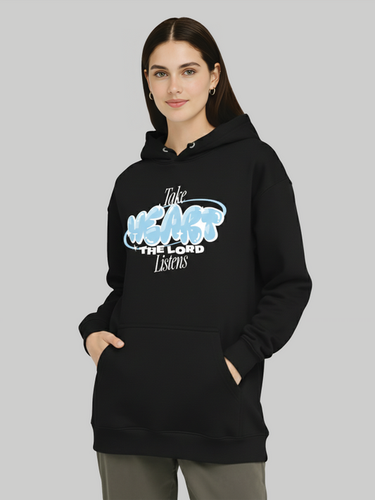Women wearing black hoodie with Take Heart The Lord Listens print