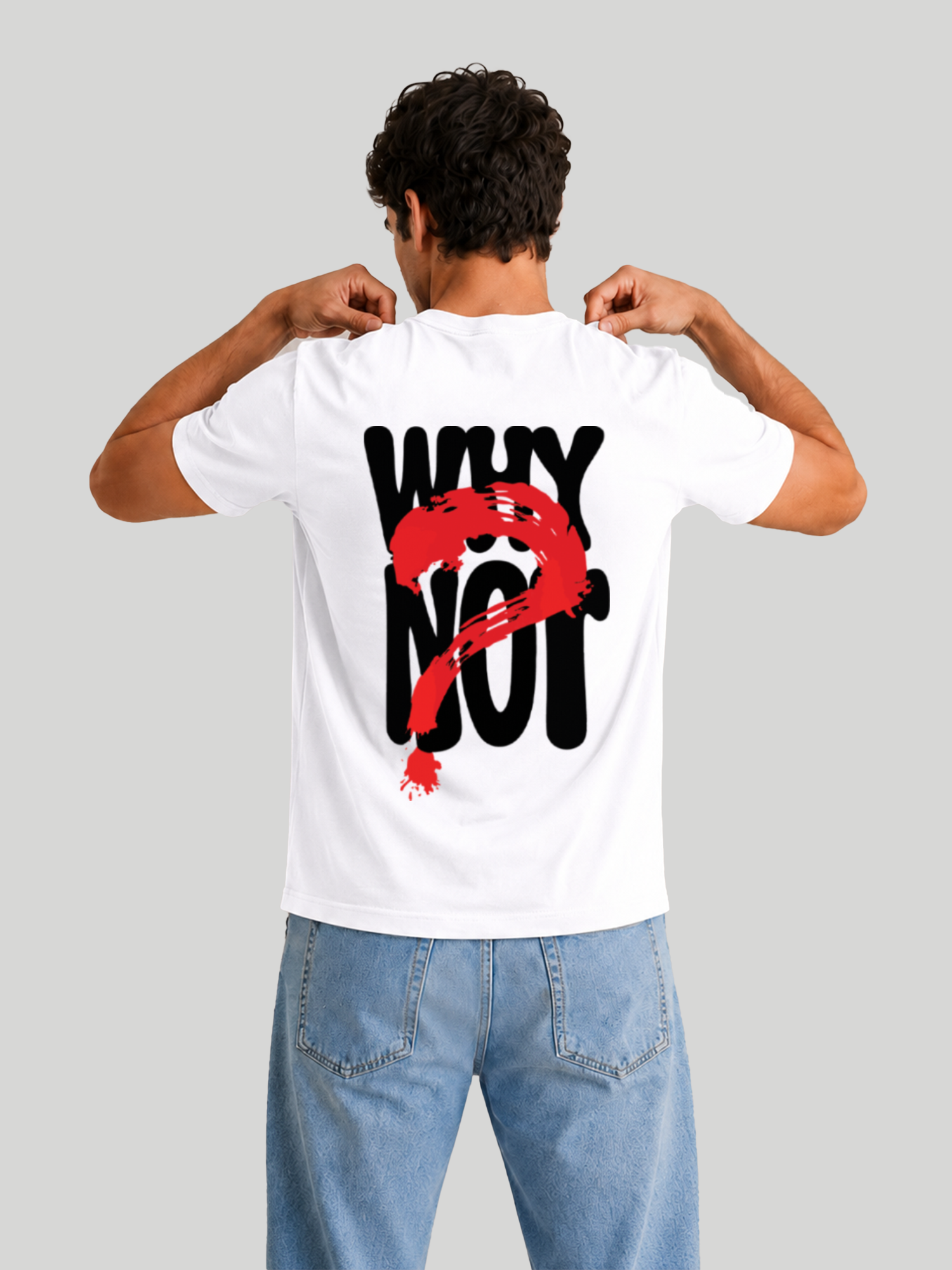 The back view of a male model wearing a white regular fit cotton t-shirt with a bold black typography print reading "WHY NOT" covered by a red brush-stroke question mark graphic, showcasing his hands pulling at the collar.