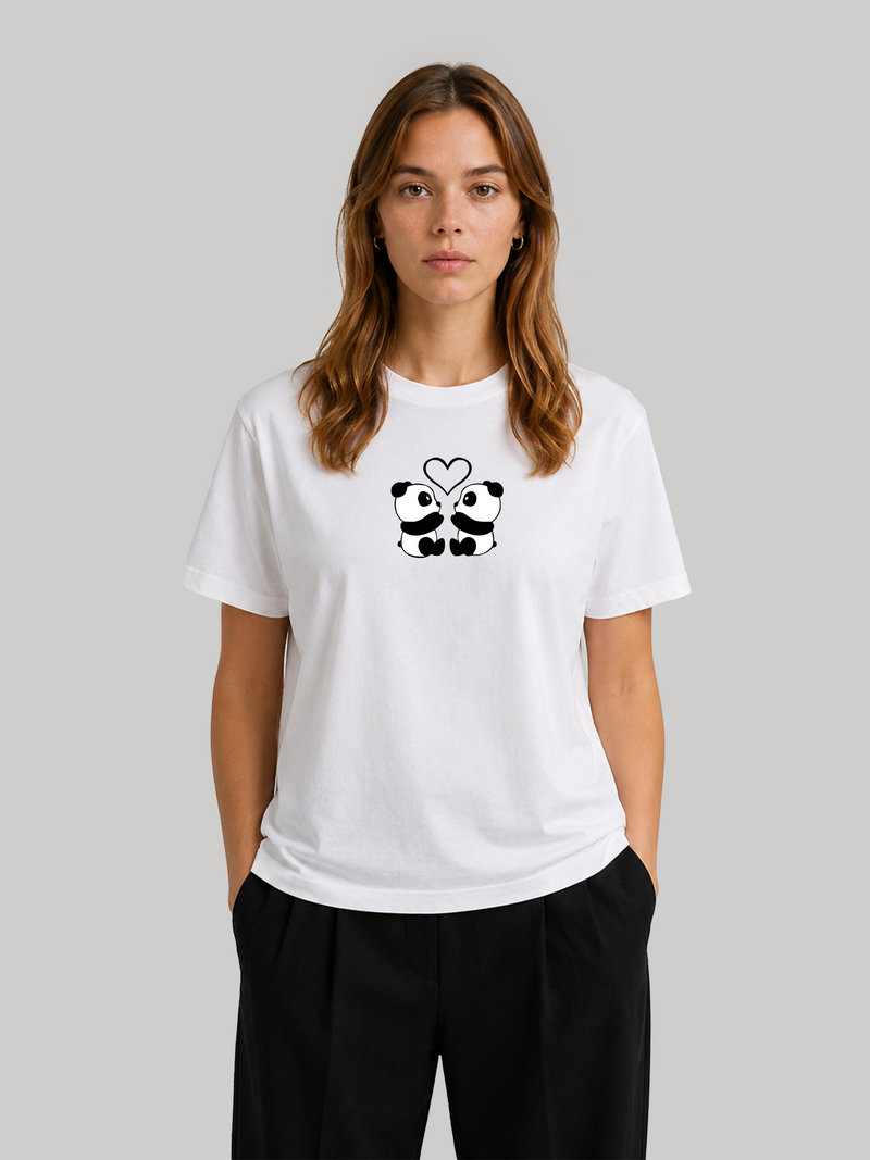 A front view of a female model standing straight with both hands in her pockets, showcasing the casual regular fit of a white cotton t-shirt with a panda chest graphic.
