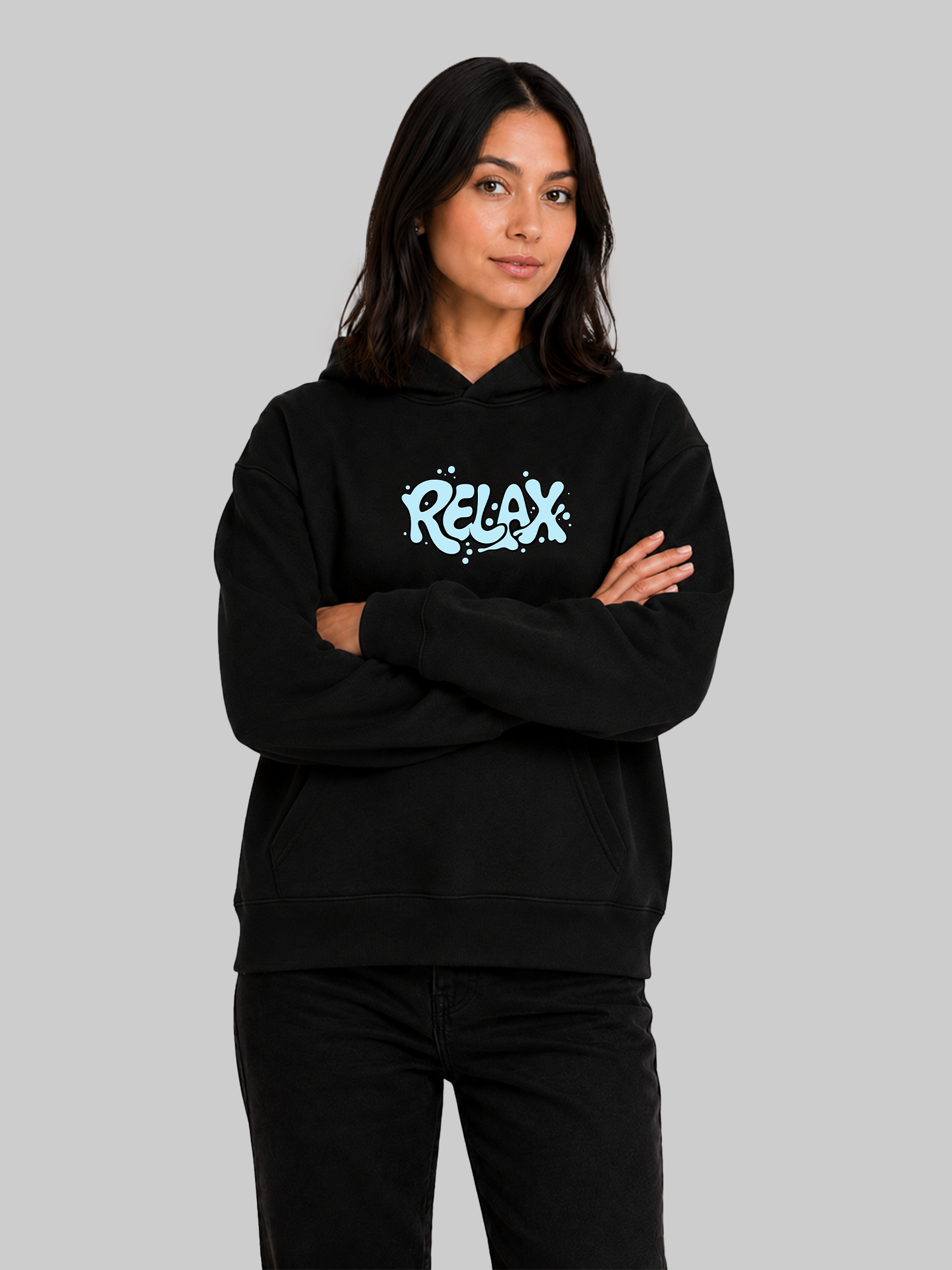 Black women's RELAX graphic hoodie with crossed arms and relaxed streetwear style