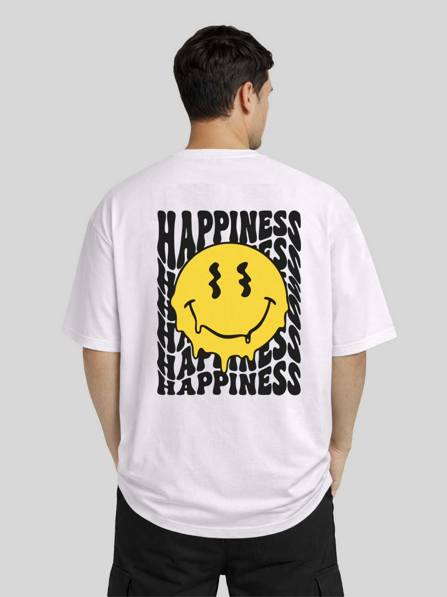 Back angled view of man wearing orchid oversized t-shirt with Happiness back graphic and yellow dripping smiley print