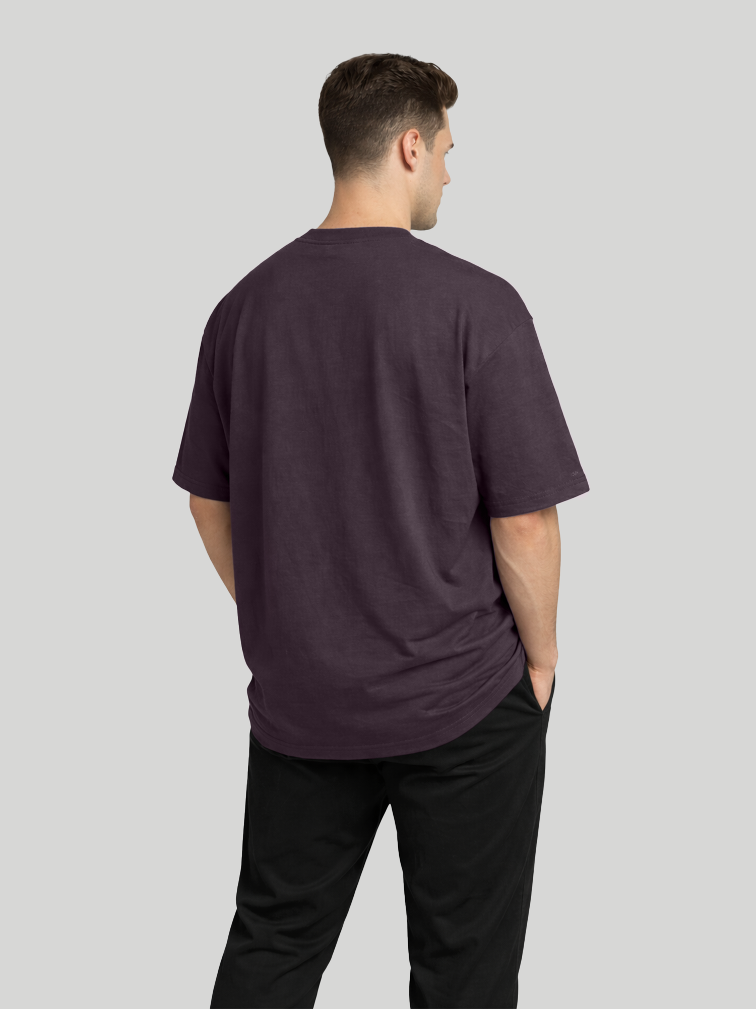 Back angled view of man wearing plum oversized t-shirt with plain back design