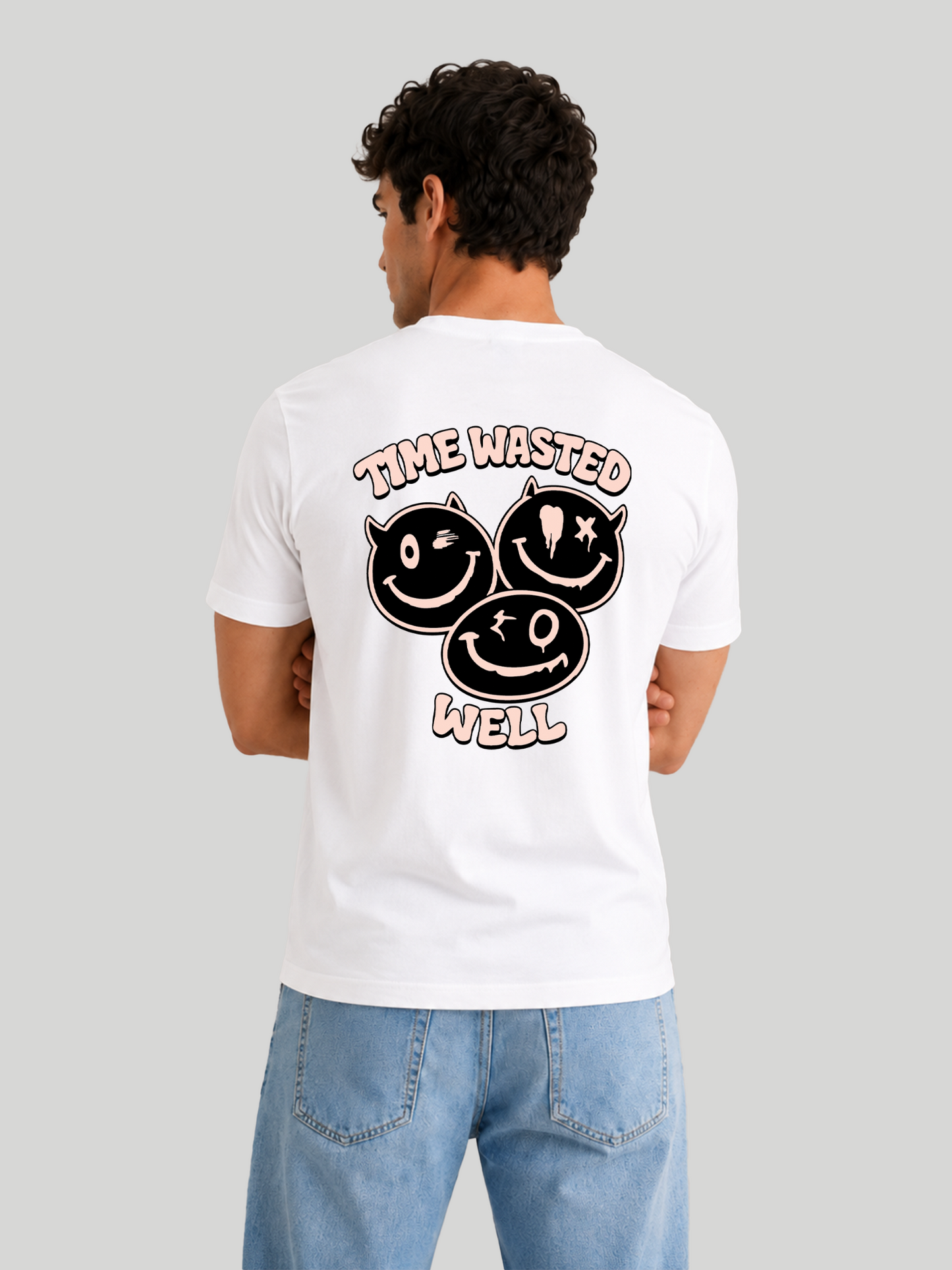A back view of a male model with his arms crossed, wearing a white regular fit crew neck t-shirt with a bold black and pink "TIME WASTED WELL" graphic design across the back.