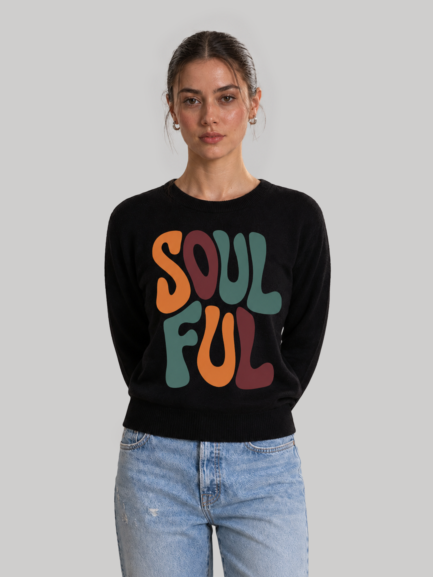 A female model standing with her hands behind her back, showcasing the comfortable and casual fit of a black custom printed graphic sweatshirt.
