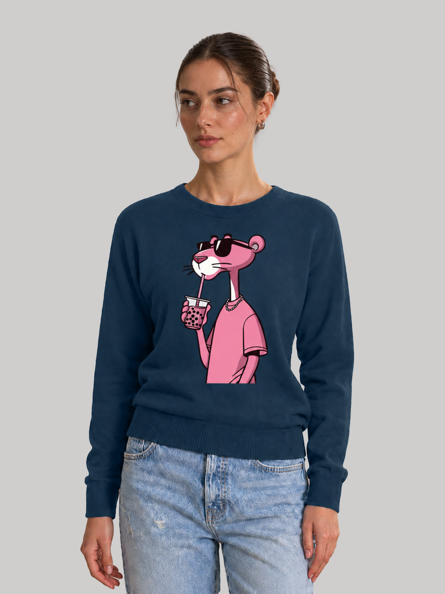 A three-quarter side view of a female model looking away, showcasing the comfortable shoulder fit and drape of a navy blue graphic printed sweatshirt.