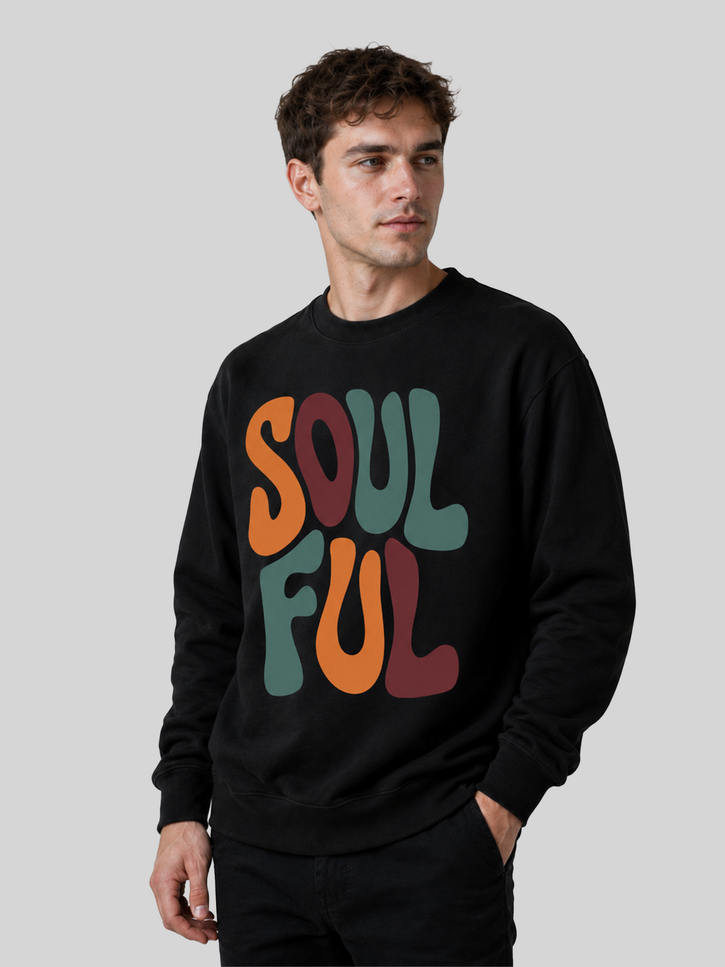 A slight three-quarter view of a male model looking to the side, wearing a black graphic sweatshirt with a bold "SOULFUL" font design.