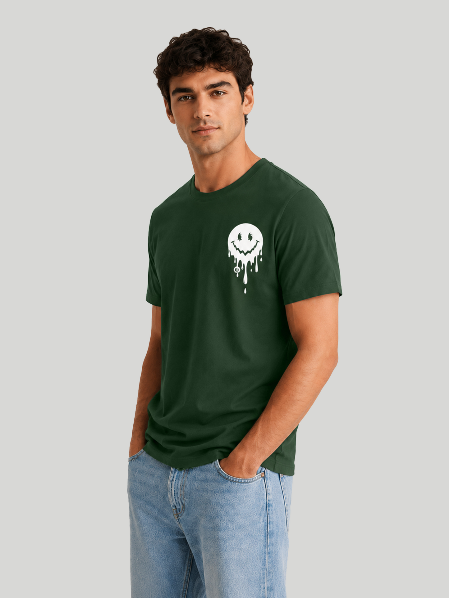 A three-quarter view of a male model looking slightly away, showcasing the comfortable shoulder drape and fit of an olive green graphic streetwear t-shirt.
