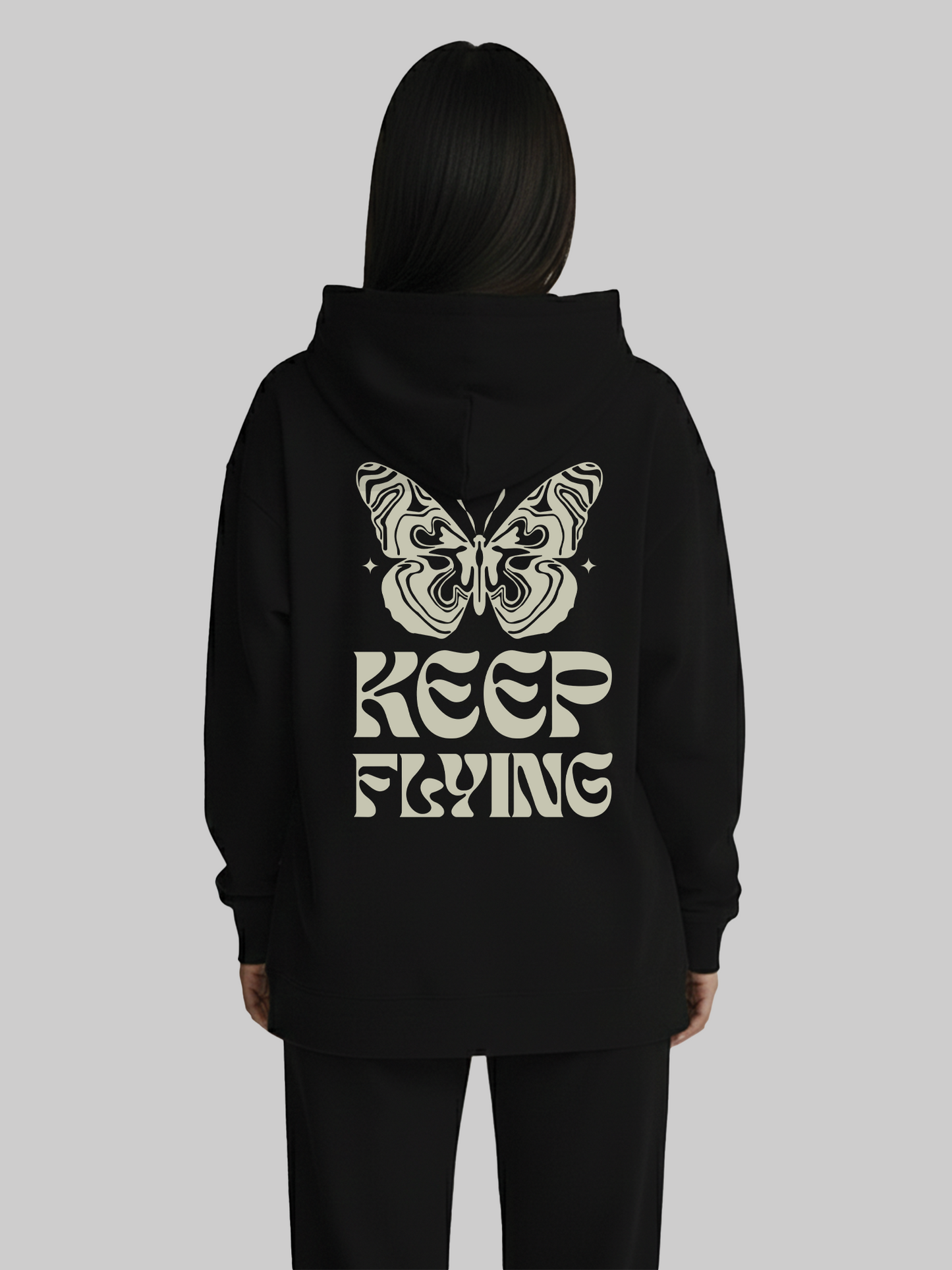 Back view of black hoodie for women with butterfly and Keep Flying graphic