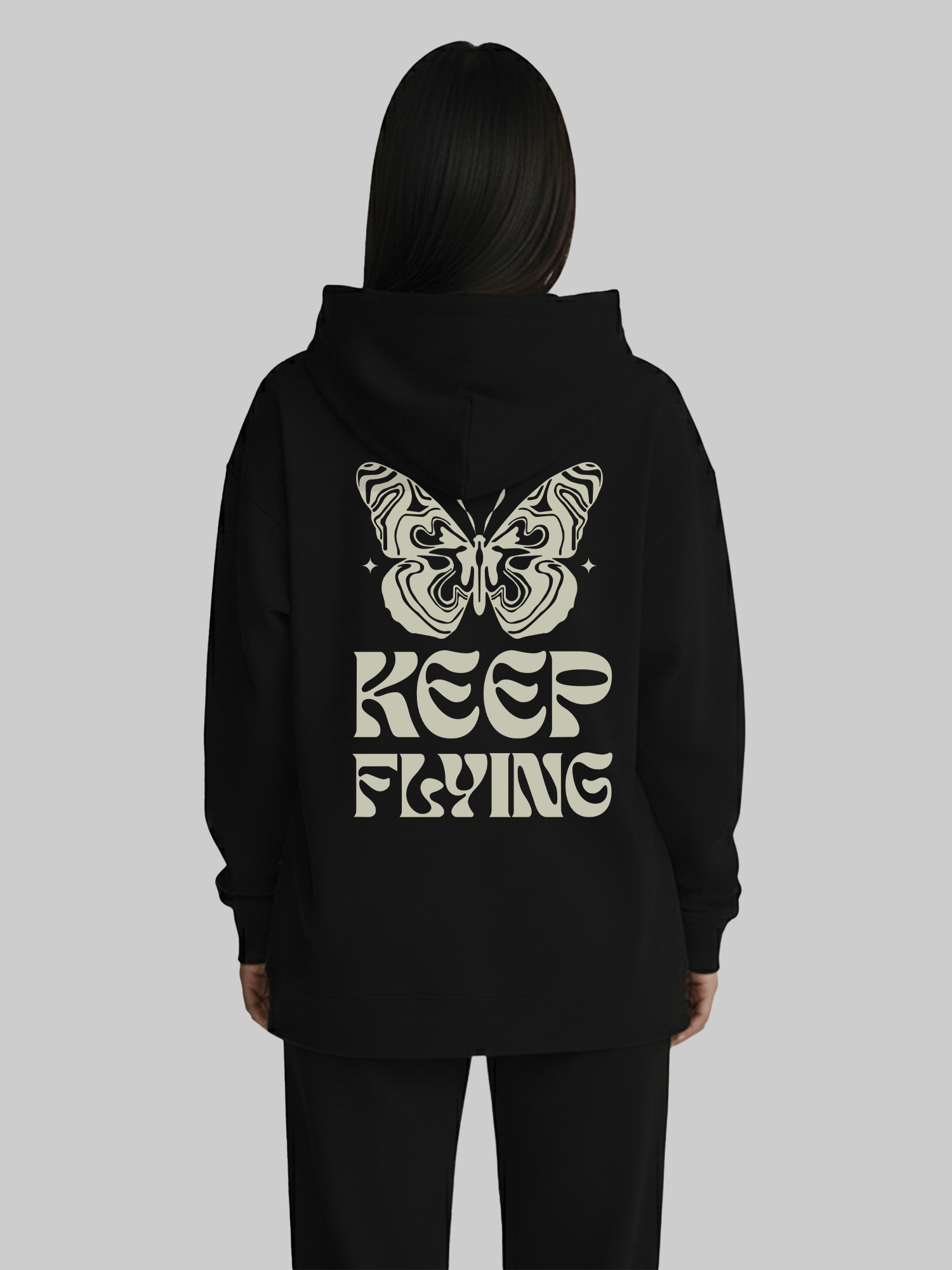 Back view of black hoodie for women with butterfly and Keep Flying graphic