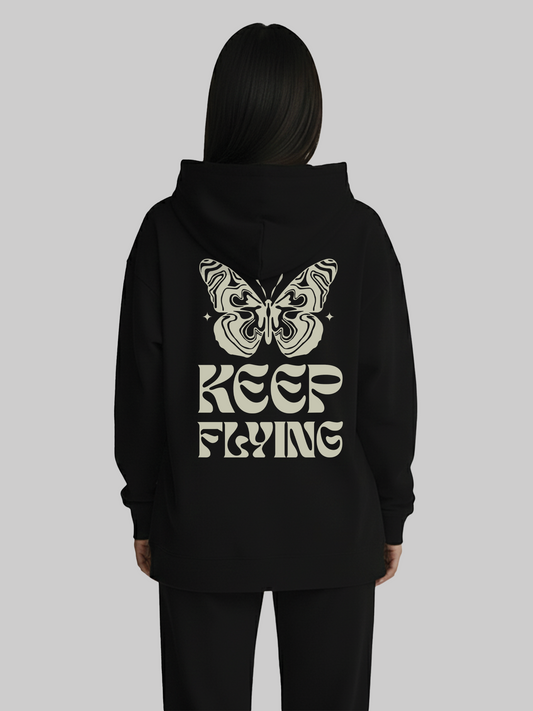 Back view of black hoodie for women with butterfly and Keep Flying graphic