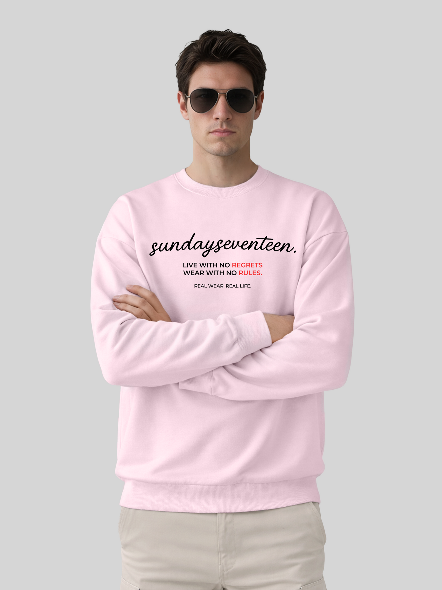 Men’s oversized orchid crewneck sweatshirt with Sundayseventeen front graphic and arms crossed pose