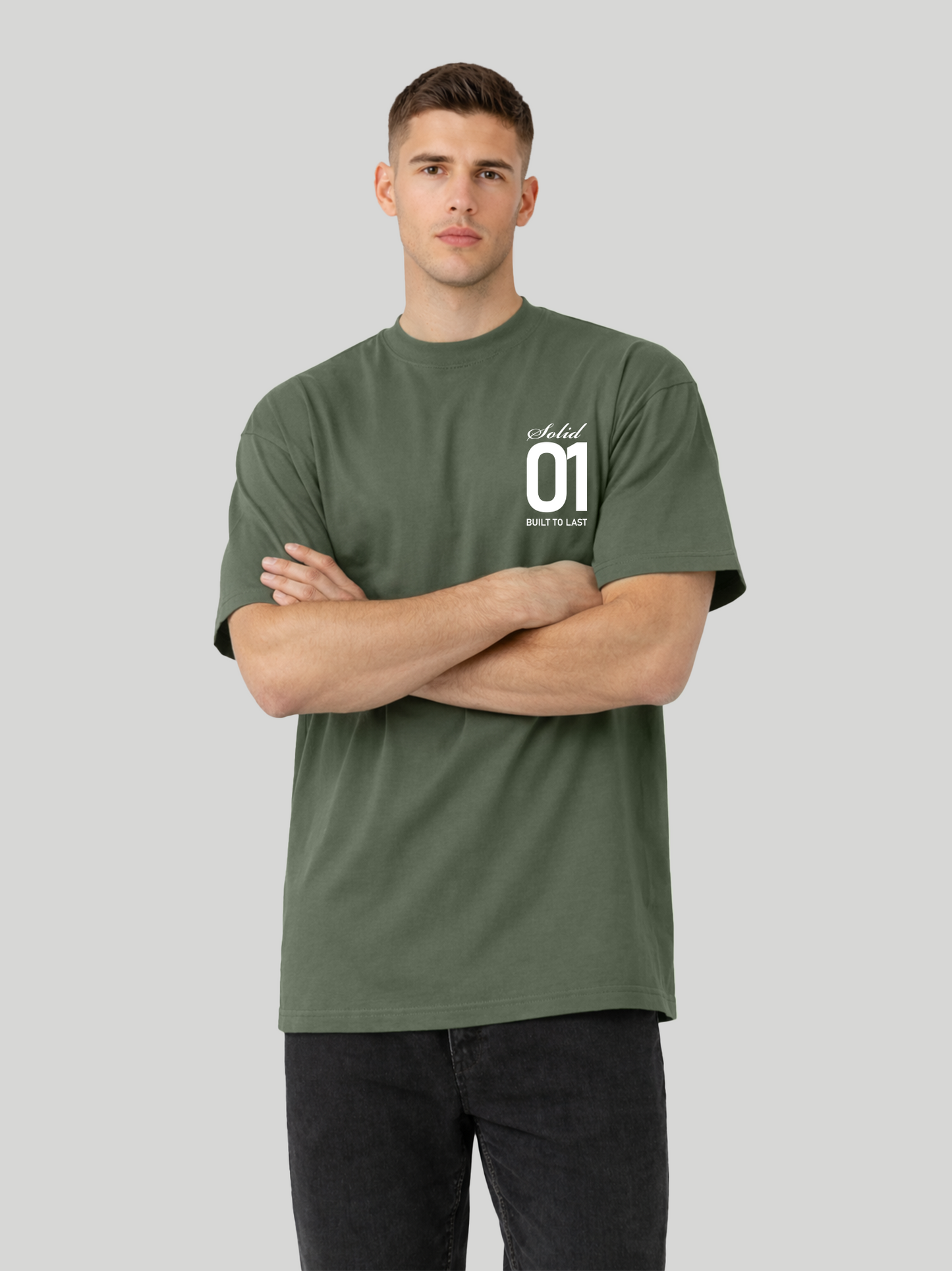 Man wearing cypress oversized t-shirt with Solid 01 chest print and arms crossed