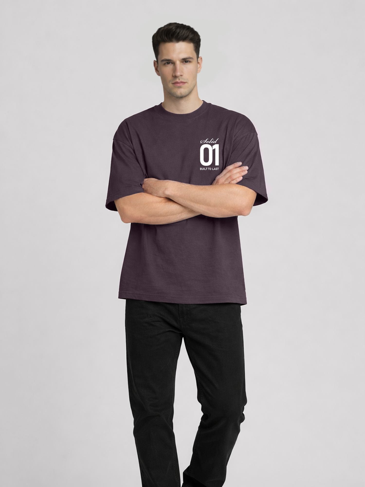 Full body view of man wearing plum oversized t-shirt with Solid 01 chest print and arms crossed