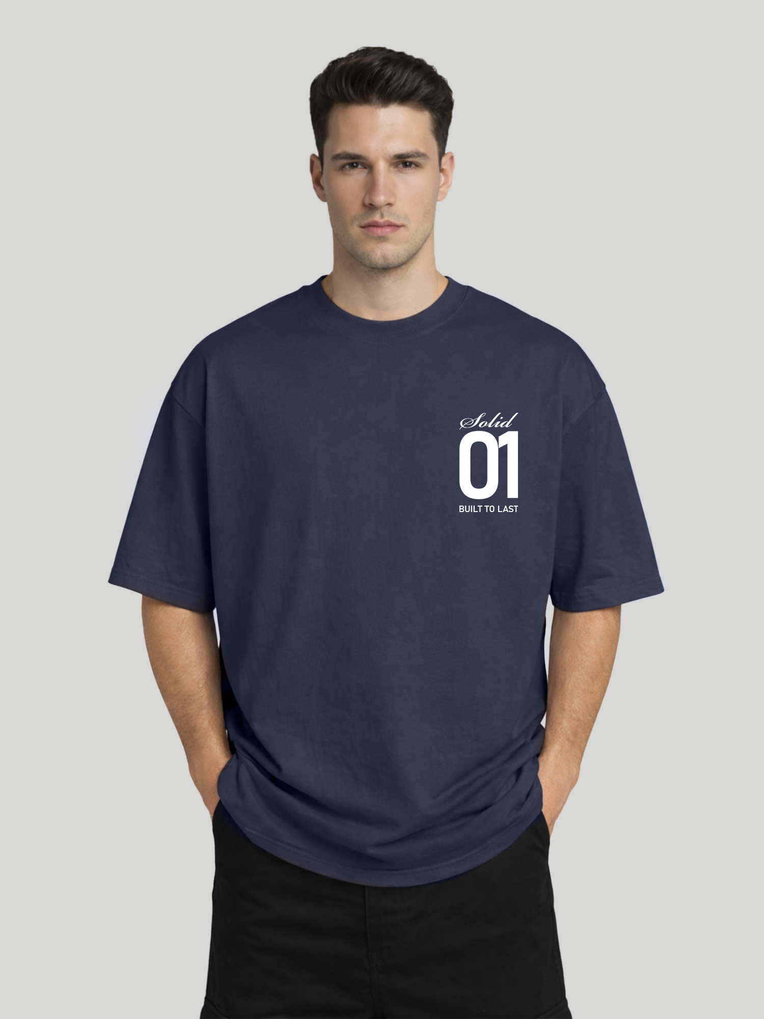 Man wearing midnight blue oversized t-shirt with Solid 01 chest print in relaxed pose with hands in pockets