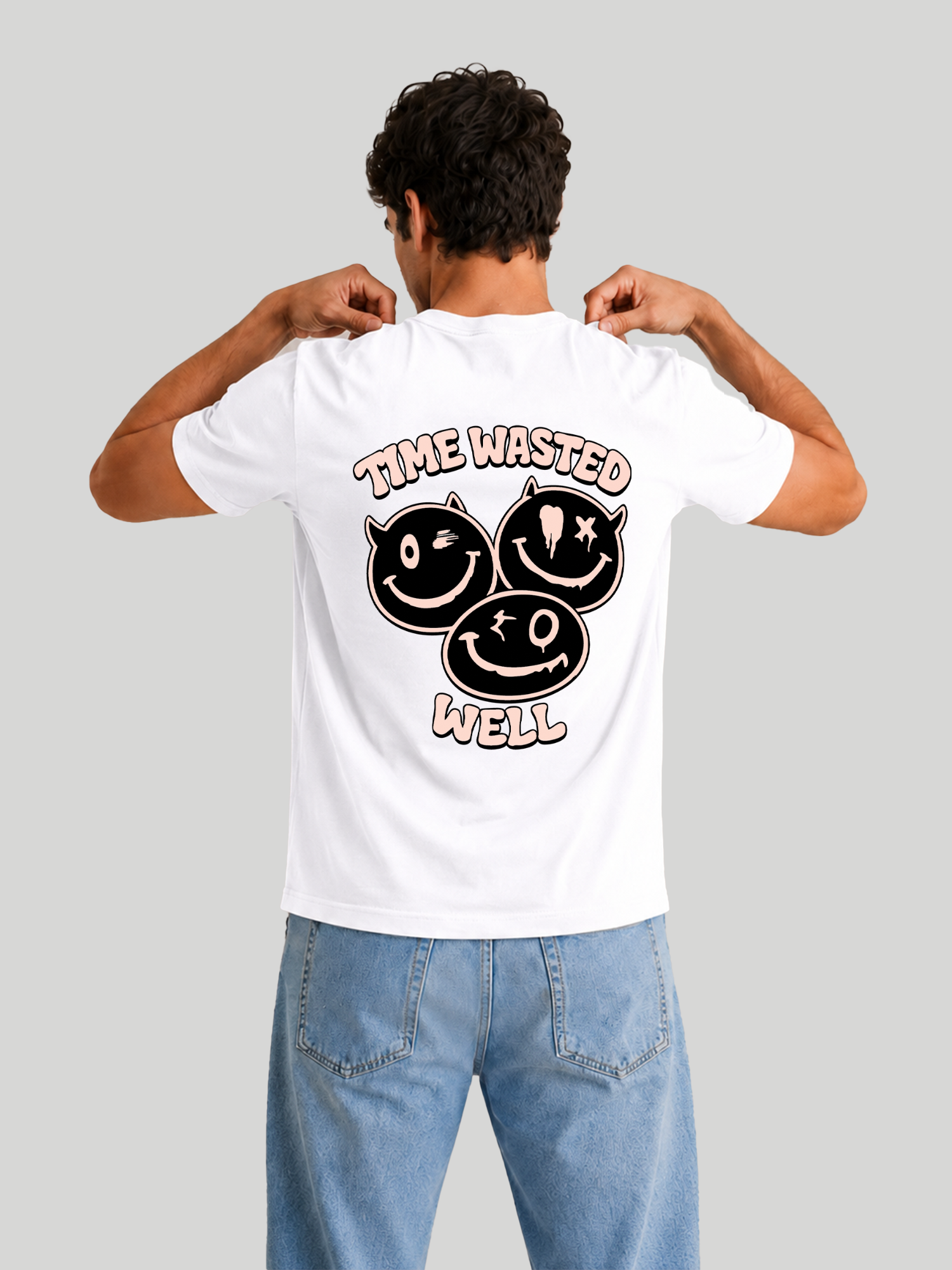 The back view of a male model adjusting his collar, wearing a white custom printed cotton t-shirt with an edgy typography and graphic print design.