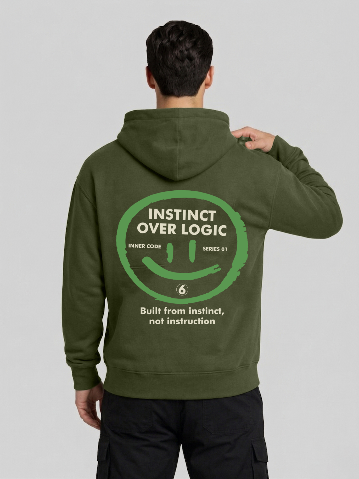 Instinct Over Logic military green hoodie for men back view with hand pose and statement print