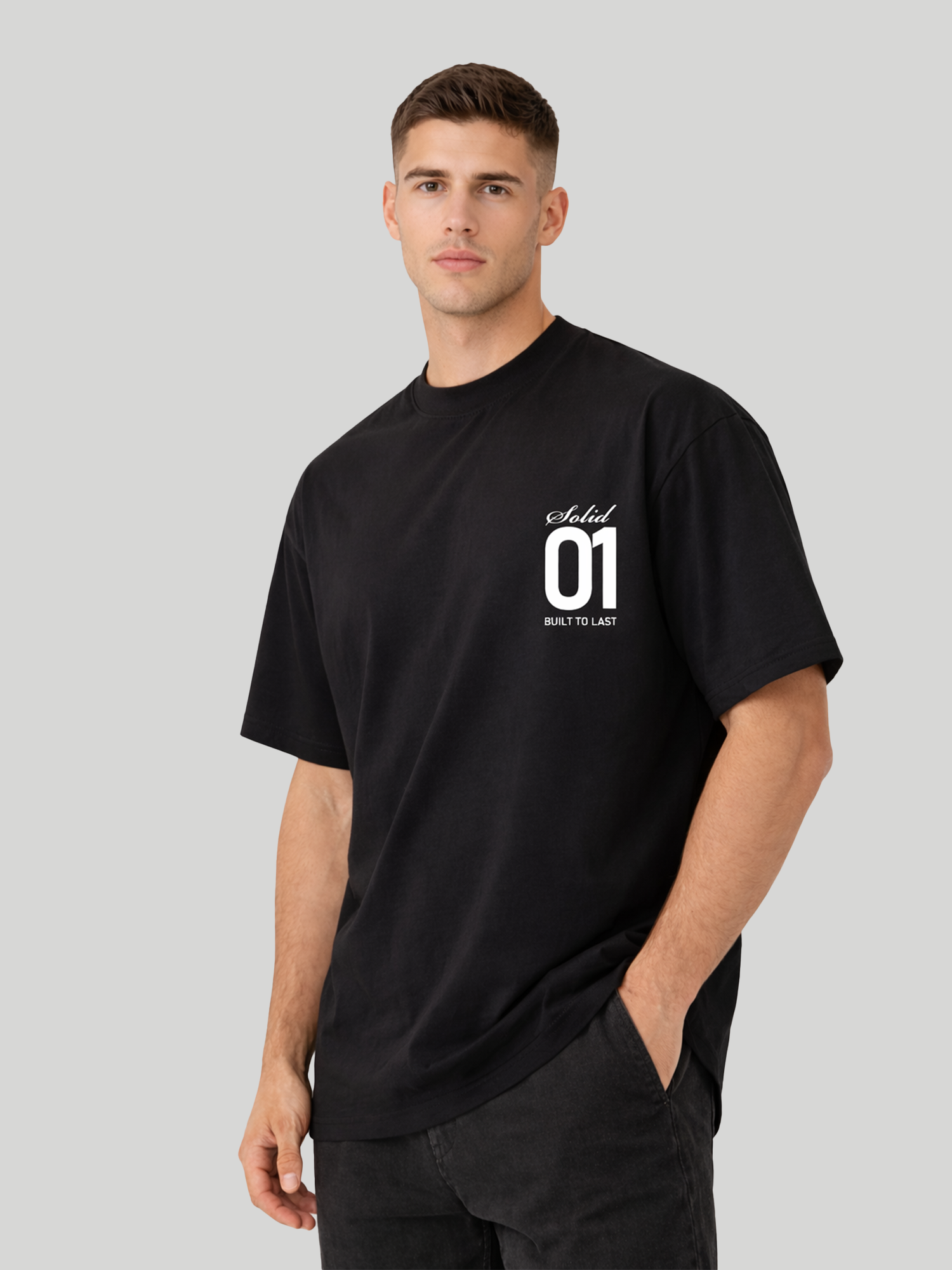 Side angle view of man wearing black oversized t-shirt with Solid 01 chest print